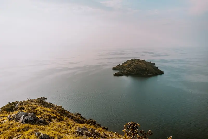 Lake Kivu Rwanda at sunset with fishing boats and green hills